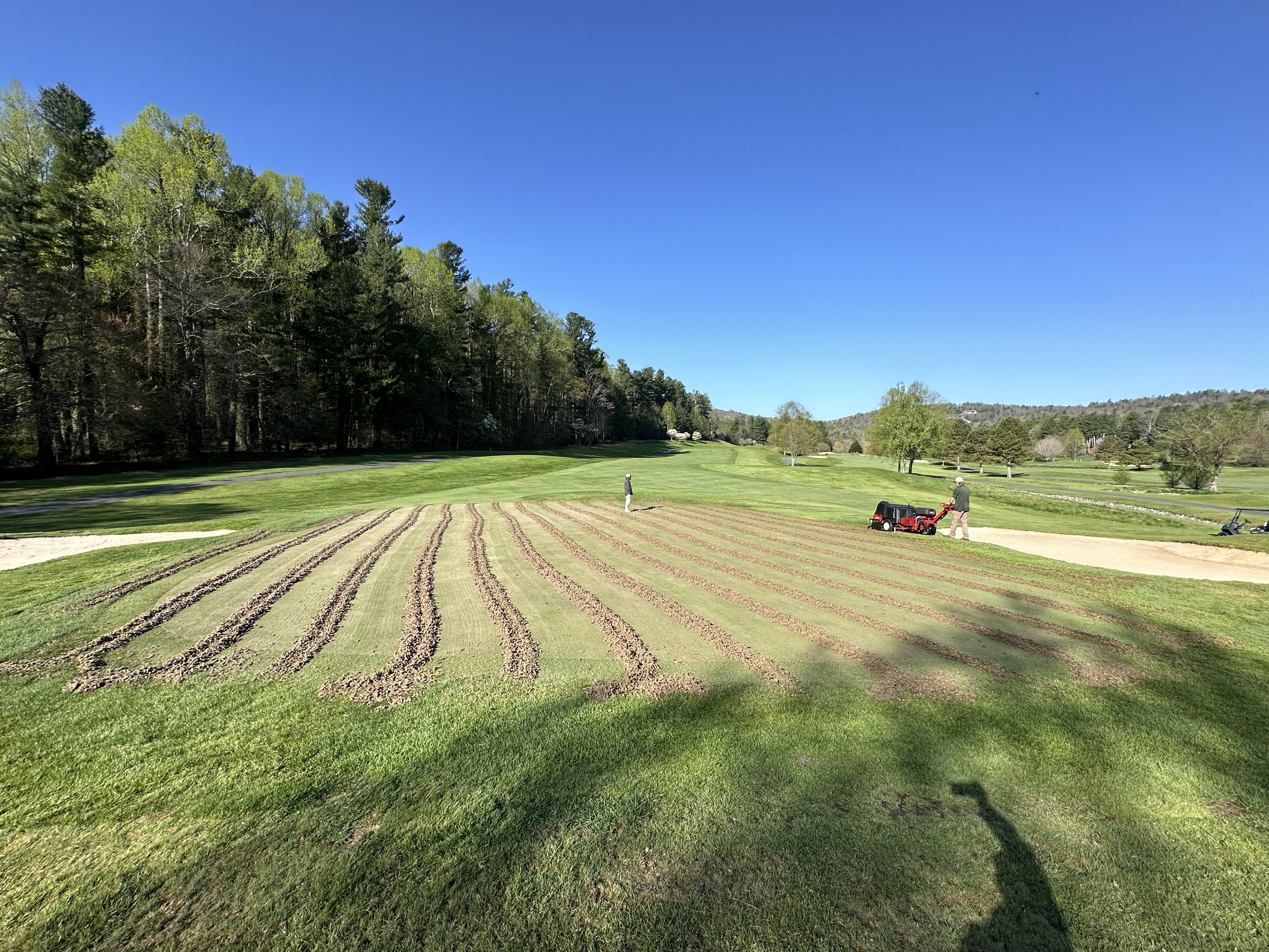 Wide-angle shot of an aerified green with uniform lines stretching toward the horizon.