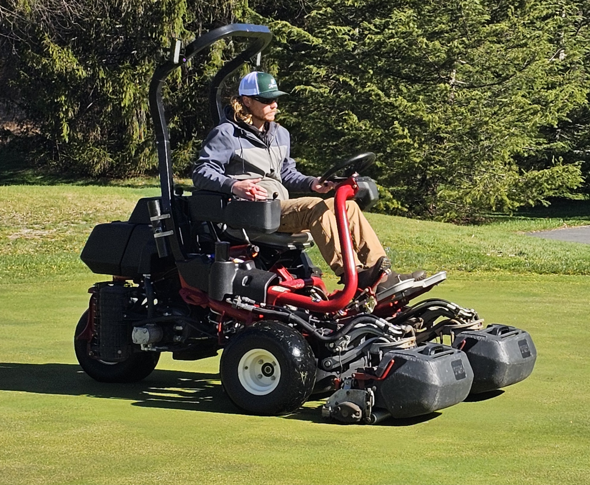 Austin mowing a green with a Toro triplex greens mower