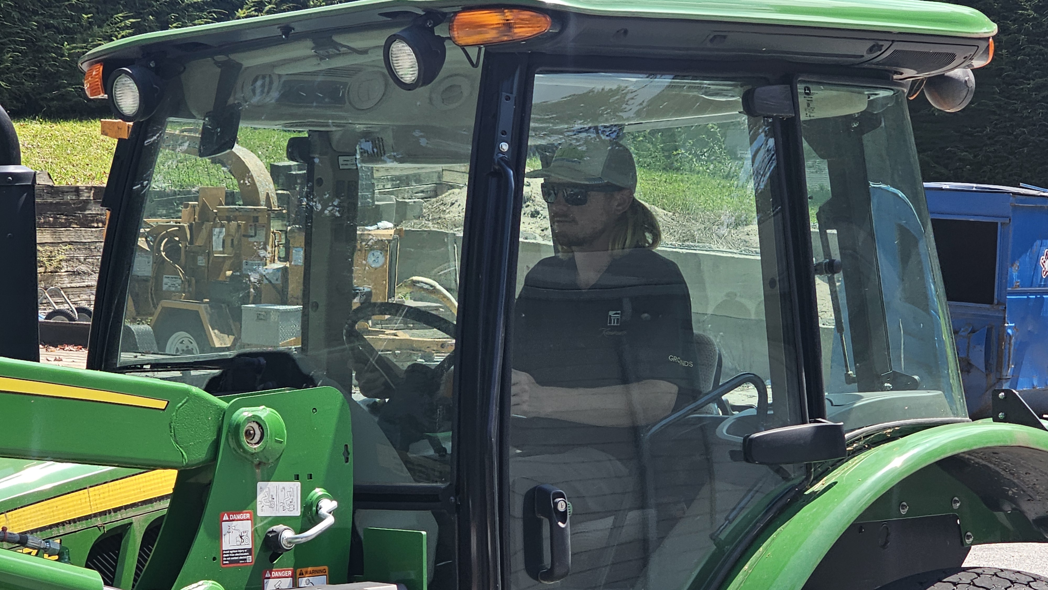 Austin focused inside a John Deere tractor cab